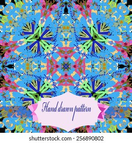 Circular seamless pattern of colored floral motifs, label on a black   background. Hand drawn.