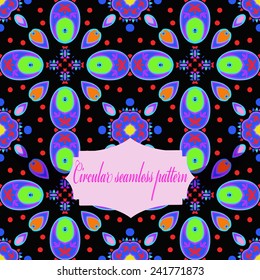 Circular seamless pattern of colored spots, label, text  on a  black  background.