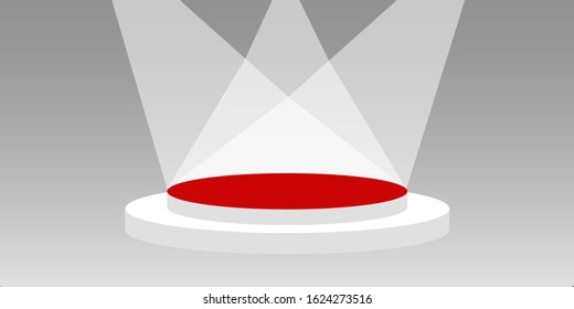 The circular stage with the red carpet has lighting on a gray abstract background.