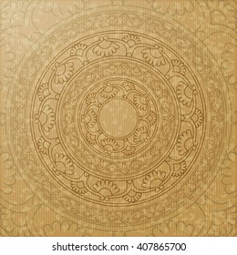 The circular symbol, the mandala. Decorative background with circular ornamental element on the background of kraft paper. Ethnic ornament.