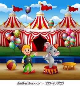Circus elephant and trainer on the arena with circus tent background