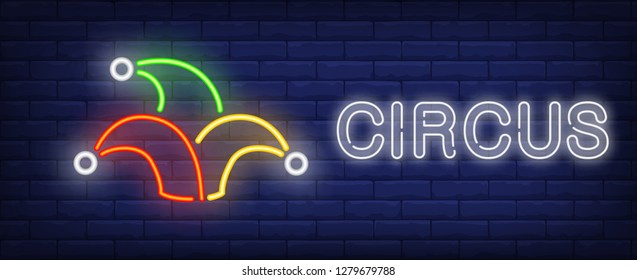 Circus neon text with jester hat. Circus performance advertisement design. Night bright neon sign, colorful billboard, light banner. Vector illustration in neon style.