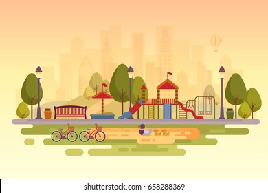 City park with playground. Sunset background.