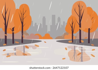 City park in rainy autumn weather. Rain in autumn park. Pedestrian path with puddles, rain splashes and reflections against the background of the city, autumn trees and silhouettes of buildings.