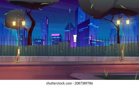 City street with park and buildings behind fence at night. Vector cartoon illustration of summer landscape with road, street lights, trees, bushes and skyscrapers on horizon