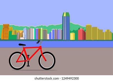 cityscape: building, river, mountain and red bicycle