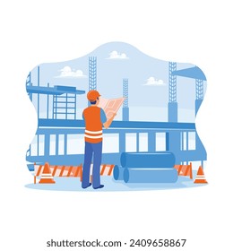 Civil engineer standing on a construction site holding a blueprint in his hand. Examining building designs and new building business workflows. Building construction sites concept.
