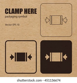 Clamp Here vector packaging symbol on vector cardboard background. Handling mark on craft paper background. Can be used on a box or packaging. Vector EPS 10.