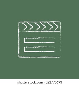 Clapboard hand drawn in chalk on a blackboard vector white icon isolated on a green background.