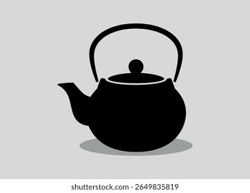 Classic black teapot with handle and spout in a simple silhouette style