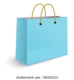 Classic blue paper shopping bag with yellow rope grips isolated on white background. View from one side.