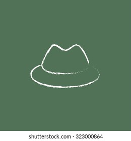 Classic hat hand drawn in chalk on a blackboard vector white icon isolated on a green background.