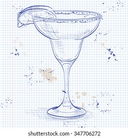 Classic margarita cocktail with lime slice and salty rim on a notebook page