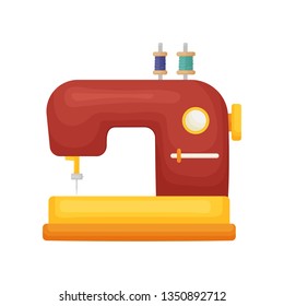 Classic model of sewing machine in red with two spools of thread isolated on white background