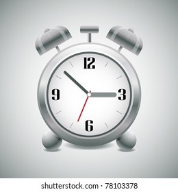 Classic silver alarm clock with bells on top