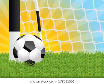 Classic soccer ball in grass near gate with sunset background
