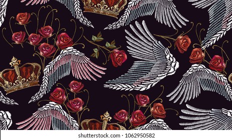 Classical embroidery wings and golden crown and spring roses seamless pattern. Symbol of romanticism and crime. Embroidery crown, wings and roses pattern. Template for clothes