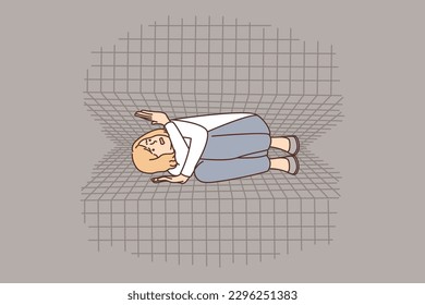 Claustrophobic woman lies between two squeezing walls symbolizing psychological pressure and phobia. Worried girl is trapped and claustrophobic experiencing lack of comfort in cramped spaces