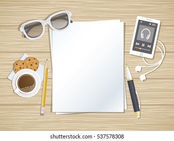 Clean sheets of paper on the wood desktop. Top view of paper, pen, pencil, smartphone running the music player, headphones, coffee, cookies, glasses. Preparation for work, notes, sketches.