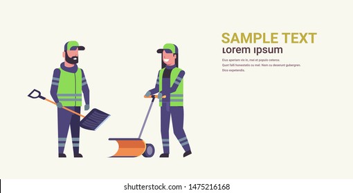 cleaners couple using plastic shovel and handle snowplough snow removal winter street cleaning service concept man woman in uniform working together flat full length horizontal copy space