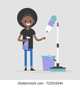 Cleaning the apartment, conceptual illustration. Black female character holding the cleaning tools: a feather duster and a spray / flat editable vector illustration, clip art