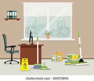 Cleaning in the office. Green colored objects for office cleaning. There is a "Caution! Wet floor" sign, a mop, a broom, a scoop and detergents near a workplace in the picture