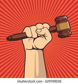 A clenched fist held high in protest holding a judge hammer