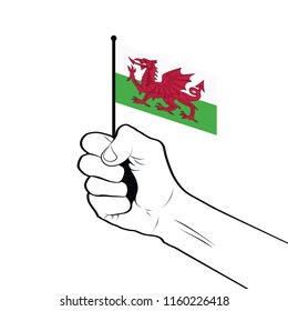Clenched fist raised in the air holding the national flag of Wales