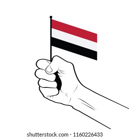 Clenched fist raised in the air holding the national flag of Yemen