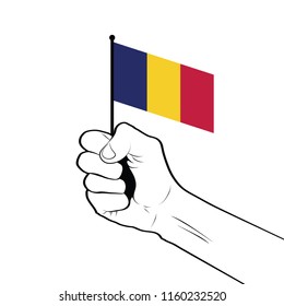 Clenched fist raised in the air holding the national flag of Chad