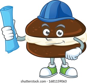 A clever Architect of whoopie pies with blue prints and blue helmet