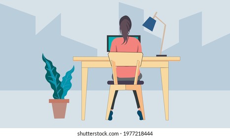 clever girl hard works in computer at home table with plants and lamp