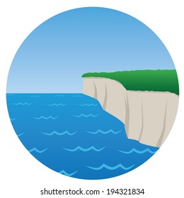 cliff on seashore with grass on top of it