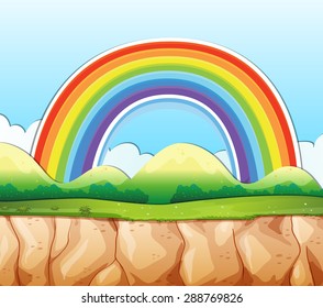 Cliff with rainbow over the mountain