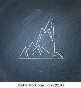 Cliff with sharp ledges icon on chalkboard. High mountain peak symbol - chalk drawing on blackboard.