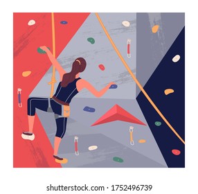 Climbing wall training. Young brunette girl climbing at training wearing sportswear rock wall. Woman using special equipment, rope. Bouldering sport. Leisure activity, sports training
