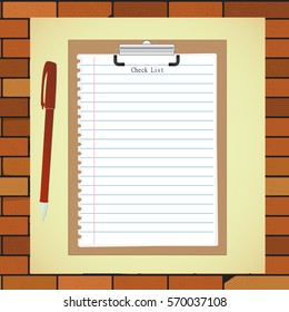 Clipboard and pen in the background of a brick wall 