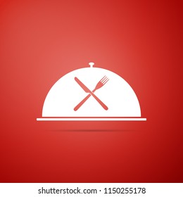 Cloche with crossed fork and knife icon isolated on red background. Restaurant symbol. Flat design. Vector Illustration