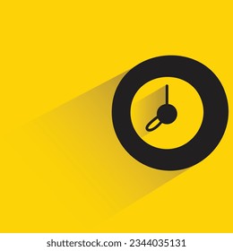 clock with shadow on yellow background