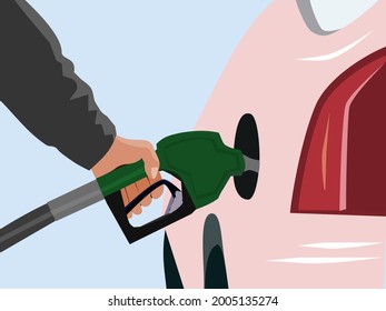 close up of arm is holding the fuel nozzle to fill the gas station with blue background