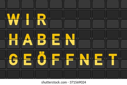 Close up of black panel flip sign with yellow letters reading wir haben geoffnet - in English saying We Are Open