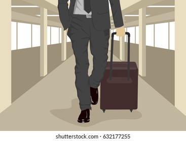 Close up of businessman carrying suitcase while walking at international airport