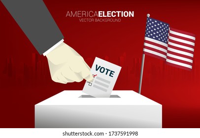 close up businessman hand put their vote to election box with america flag. concept for USA election vote theme background.