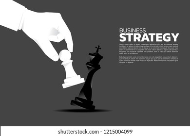 close up businessman hand take a checkmate on chess board game. concept of business strategy and win competition.