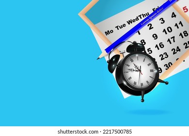 Close up of calendar and alarm clock on blue background, business meeting planning or trip planning concept.