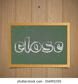 Close. Chalk board with wooden frame on a wooden background