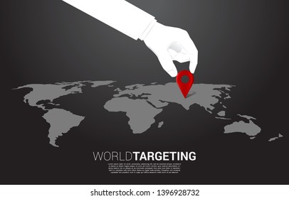 close up hand of businessman place location pin marker in front of world map. concept of business set up, vision mission and goal