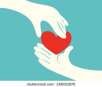 Close up of hand giving a red heart to another hand on green background