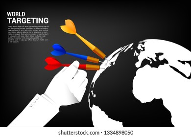 close up hand hold dart arrow hit at the globe. Business Concept of global marketing target and customer.Company vision mission and goal.