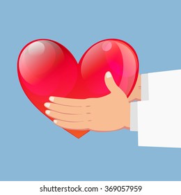 Close up of Hands holding red heart on blue background